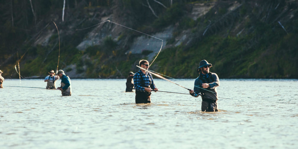 men flyfishing on river