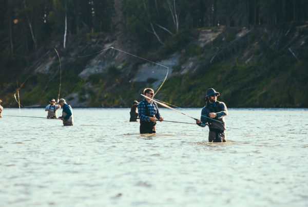 men flyfishing on river